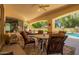 Spacious covered patio with ample seating, overlooking the lush backyard and sparkling pool at 5534 W Riviera Dr, Glendale, AZ 85304