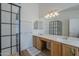 Modern bathroom with dual sinks, a glass-enclosed shower, and stylish fixtures at 5919 W Blackhawk Dr, Glendale, AZ 85308
