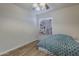 Bright bedroom featuring hard floors, a ceiling fan, and a cute, patterned curtain at 5919 W Blackhawk Dr, Glendale, AZ 85308
