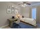 Inviting bedroom featuring stylish décor, a cozy bed, a dedicated workspace, and calming natural light at 5919 W Blackhawk Dr, Glendale, AZ 85308