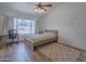 Bright bedroom with a large window, featuring a cozy bed and a dedicated workspace at 5919 W Blackhawk Dr, Glendale, AZ 85308