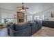 Comfortable living room with a brick fireplace, adjacent to the dining area and kitchen at 5919 W Blackhawk Dr, Glendale, AZ 85308