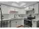 Updated kitchen featuring modern white cabinets, subway tile backsplash, and stainless steel appliances at 6008 W Augusta Ave, Glendale, AZ 85301