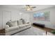 Cozy living room with neutral sofa, ceiling fan and large window at 6008 W Augusta Ave, Glendale, AZ 85301