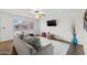 Comfortable living room with mounted TV, stylish decor, and ceiling fan at 6008 W Augusta Ave, Glendale, AZ 85301