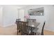 Dining area with modern table and chairs adjacent to the living room, creating an open and inviting space at 7027 W Midway Ave, Glendale, AZ 85303