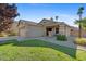 Inviting curb appeal with a charming front porch, desert landscaping, and a two-car garage at 7027 W Midway Ave, Glendale, AZ 85303
