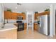 Well-maintained kitchen with stainless steel appliances, light wood cabinets, and a convenient pantry, perfect for cooking at 7027 W Midway Ave, Glendale, AZ 85303