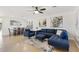 Inviting living room with blue sofa, chair, modern art, and tile flooring near the dining area, perfect for entertaining guests at 7027 W Midway Ave, Glendale, AZ 85303