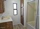 The bathroom features a shower, vanity, and window to complete the design and functionality of the space at 730 S Country Club Dr # 62, Mesa, AZ 85210