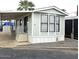 Charming single-story home featuring a covered entrance, white trim, and well-maintained landscaping at 730 S Country Club Dr # 62, Mesa, AZ 85210