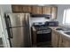 Kitchen featuring stainless steel appliances and wood cabinetry at 730 S Country Club Dr # 62, Mesa, AZ 85210