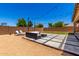 Wide backyard view showcasing modern patio furniture, desert landscaping, and string lights at 820 E Constance Way, Phoenix, AZ 85042