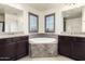 Elegant bathroom featuring a soaking tub with granite countertops and shuttered windows at 820 E Constance Way, Phoenix, AZ 85042