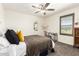 Bright bedroom with neutral walls, ceiling fan, carpet, and a window with shutters at 820 E Constance Way, Phoenix, AZ 85042
