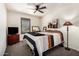 Cozy bedroom featuring neutral walls, carpet, a ceiling fan, and a window with shutters at 820 E Constance Way, Phoenix, AZ 85042
