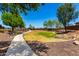 Picturesque community park with walking path, green space, and inviting benches surrounded by mature trees at 820 E Constance Way, Phoenix, AZ 85042