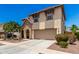 Charming two-story home with stone facade, arched entryway, desert landscaping, and a spacious two-car garage at 820 E Constance Way, Phoenix, AZ 85042