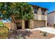Charming two-story home with neutral stucco, a stone pillar entryway, and desert landscaping at 820 E Constance Way, Phoenix, AZ 85042