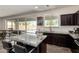 The kitchen features dark cabinets, an island with barstool seating, and sliding glass doors to the backyard at 820 E Constance Way, Phoenix, AZ 85042