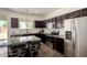 This kitchen features dark cabinets, stainless steel appliances, granite counters, and a tiled floor at 820 E Constance Way, Phoenix, AZ 85042