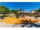 Community playground with a slide, climbing wall, and benches, surrounded by mature trees and landscaping at 820 E Constance Way, Phoenix, AZ 85042
