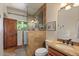 Bathroom with a stand-up shower, single sink vanity, and dark stained cabinets at 8306 E Buckskin Trl, Scottsdale, AZ 85255
