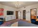 Bright bedroom with stone floors, modern furniture, and access to a bathroom at 8306 E Buckskin Trl, Scottsdale, AZ 85255