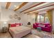 Charming bedroom with exposed beams, a unique fireplace, and stylish furnishings at 8306 E Buckskin Trl, Scottsdale, AZ 85255