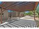 Covered carport featuring a wooden pergola providing shade and style at 8306 E Buckskin Trl, Scottsdale, AZ 85255