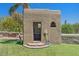 Charming casita exterior with a small bathroom, surrounded by lush greenery and desert landscaping at 8306 E Buckskin Trl, Scottsdale, AZ 85255