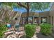 Private courtyard surrounded by the house with mature trees and outdoor seating area at 8306 E Buckskin Trl, Scottsdale, AZ 85255