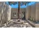 Charming courtyard featuring desert plants and natural stone elements, enhancing curb appeal at 8306 E Buckskin Trl, Scottsdale, AZ 85255