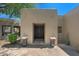 Stately front entrance featuring a decorative door and lush landscaping on a stone patio at 8306 E Buckskin Trl, Scottsdale, AZ 85255