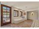 Bright entryway with a built-in bench, stone floors, and a wooden front door at 8306 E Buckskin Trl, Scottsdale, AZ 85255