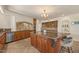 Well-appointed kitchen with center island, custom cabinets, stainless steel appliances, and stylish tile backsplash at 8306 E Buckskin Trl, Scottsdale, AZ 85255