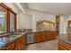Spacious kitchen with stainless appliances, granite countertops, stone floors and a bright, sunny window at 8306 E Buckskin Trl, Scottsdale, AZ 85255