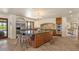 Spacious open kitchen features a large central island, stainless steel appliances, and tile backsplash at 8306 E Buckskin Trl, Scottsdale, AZ 85255