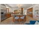 Bright kitchen boasts a central island, stainless appliances, custom cabinetry, and durable stone flooring at 8306 E Buckskin Trl, Scottsdale, AZ 85255