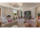 Spacious living room featuring a decorative chandelier, comfortable seating and a large TV at 8306 E Buckskin Trl, Scottsdale, AZ 85255