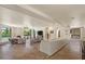 Open-concept living room with stone floors, fireplace, and natural light at 8306 E Buckskin Trl, Scottsdale, AZ 85255
