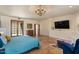Bright primary bedroom with stone floors, recessed lighting, and an entertainment center at 8306 E Buckskin Trl, Scottsdale, AZ 85255