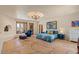 Spacious primary bedroom features stone floors, recessed ceiling with stylish chandelier, and ample natural light at 8306 E Buckskin Trl, Scottsdale, AZ 85255