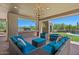 Covered patio features a built-in grill, ample seating, and views of pool and desert landscape at 8306 E Buckskin Trl, Scottsdale, AZ 85255