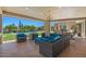 Covered outdoor patio with comfortable seating, a chandelier, and view of the pool and desert landscape at 8306 E Buckskin Trl, Scottsdale, AZ 85255