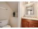 Cozy half bathroom with wood vanity and decorative mirror at 9011 N 52Nd Ave, Glendale, AZ 85302