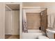 Bright bathroom featuring a shower-tub combo with neutral tile surround at 9011 N 52Nd Ave, Glendale, AZ 85302