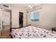 This bedroom features a window, ceiling fan, and closet to keep organized at 9011 N 52Nd Ave, Glendale, AZ 85302