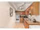 Well-lit kitchen with wooden cabinets, neutral countertops, and stainless steel appliances at 9011 N 52Nd Ave, Glendale, AZ 85302