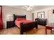 Comfortable main bedroom with dark wood furniture, ceiling fan and natural light at 9011 N 52Nd Ave, Glendale, AZ 85302